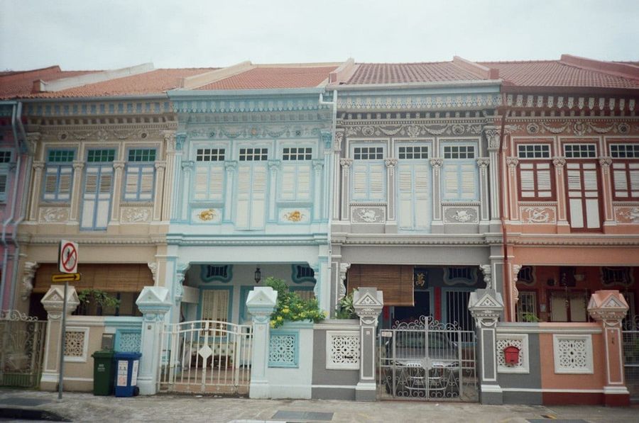 Traditional shophouses along a leafy Singapore street